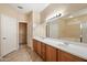 Spacious bathroom features double sinks, a walk-in closet, and a large vanity mirror at 20900 N Vista Trl, Surprise, AZ 85387