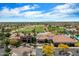 Elegant clubhouse with palm trees, desert landscaping, and a golf course in the background at 20900 N Vista Trl, Surprise, AZ 85387
