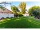 A landscaped backyard features artificial turf, flower beds and a green trampoline at 2139 S Granite St, Gilbert, AZ 85295