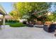 Landscaped backyard with artificial turf, trampoline, cozy fire pit, and outdoor seating, designed for Gathering fun and relaxation at 2139 S Granite St, Gilbert, AZ 85295