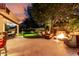 Spacious backyard featuring a patio, outdoor seating, fire pit, and manicured lawn at 2139 S Granite St, Gilbert, AZ 85295