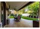 A covered backyard patio includes a ceiling fan, outdoor TV, and dining area at 2139 S Granite St, Gilbert, AZ 85295