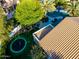 Aerial view showcasing a backyard with a trampoline, firepit, manicured lawn and covered patio at 2139 S Granite St, Gilbert, AZ 85295