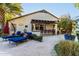Covered patio area, outdoor bar with chairs, and lush landscaping providing the perfect setting for entertaining guests at 2139 S Granite St, Gilbert, AZ 85295