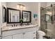 Elegant bathroom featuring a double vanity with granite countertop and a glass-enclosed shower at 2139 S Granite St, Gilbert, AZ 85295