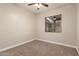 Bedroom featuring neutral walls and carpet, a ceiling fan, and window views at 2139 S Granite St, Gilbert, AZ 85295