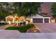 Charming home featuring a brick driveway, lush lawn, and mature tree shading the facade at 2139 S Granite St, Gilbert, AZ 85295