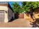 Home's exterior showcasing a private gate, three-car garage, and large driveway at 2139 S Granite St, Gilbert, AZ 85295