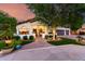 Charming facade with lush landscaping, brick walkway, and inviting front patio seating area at 2139 S Granite St, Gilbert, AZ 85295