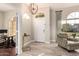 The foyer welcomes guests with a unique light fixture, light walls and floors, and neutral decor at 2139 S Granite St, Gilbert, AZ 85295