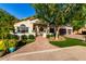 Attractive single-story home with lush front yard, brick pathway, and a shade tree that enhances curb appeal at 2139 S Granite St, Gilbert, AZ 85295