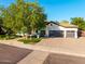 An updated home boasts mature landscaping, charming curb appeal, and a three-car garage at 2139 S Granite St, Gilbert, AZ 85295