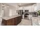 Modern kitchen featuring stainless steel appliances and a kitchen island with granite countertops at 2139 S Granite St, Gilbert, AZ 85295