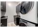 Well-lit laundry room with granite countertops, dark cabinets, and stacked washer/dryer at 2139 S Granite St, Gilbert, AZ 85295