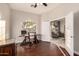 Bright home office space featuring wood floors, neutral paint, and a view to the living room at 2139 S Granite St, Gilbert, AZ 85295