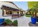 An outdoor kitchen features a covered bar with seating, lush landscaping, and a view of the pool, perfect for entertaining at 2139 S Granite St, Gilbert, AZ 85295