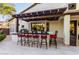 A covered outdoor kitchen is fitted with bar stool seating and a built-in grill, creating an ideal spot for outdoor dining at 2139 S Granite St, Gilbert, AZ 85295