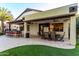 Beautiful outdoor living space features outdoor dining, a kitchen area, and a lush lawn, blending relaxation with entertainment at 2139 S Granite St, Gilbert, AZ 85295
