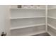 Spacious walk-in pantry with white shelving and ample storage for kitchen and household goods at 2139 S Granite St, Gilbert, AZ 85295
