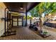 Covered patio with storage and a mini-bike, perfect for outdoor activities and storing gardening equipment at 2139 S Granite St, Gilbert, AZ 85295
