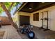 Spacious covered patio with recreational pull-up bar and mini-bike, offering a versatile outdoor space at 2139 S Granite St, Gilbert, AZ 85295