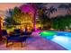 Inviting backyard area with a large pool, lounge chairs, and mature landscaping at 2139 S Granite St, Gilbert, AZ 85295