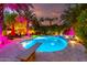Backyard pool showcasing a diving board, water features, and vibrant, colorful lighting at 2139 S Granite St, Gilbert, AZ 85295