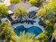 Aerial view of a backyard featuring a freeform pool, lounge area and outdoor bar with seating at 2139 S Granite St, Gilbert, AZ 85295