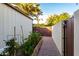 Side yard with raised garden and brick paver path, perfect for gardening and outdoor enjoyment at 2139 S Granite St, Gilbert, AZ 85295