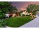 Well-manicured front yard with green lawn, flowering bushes, and mature shade trees at 2139 S Granite St, Gilbert, AZ 85295