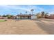 Home's rear exterior showing palm trees, spacious backyard, and covered patio at 22312 W Hammond Dr, Buckeye, AZ 85326