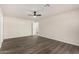 Spacious bedroom features modern ceiling fan, neutral walls, and wood-look flooring for a clean, contemporary feel at 22312 W Hammond Dr, Buckeye, AZ 85326