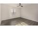 Bedroom has natural light, a modern ceiling fan, and laminate flooring, creating a bright and inviting space at 22312 W Hammond Dr, Buckeye, AZ 85326