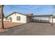 Home exterior featuring a carport with a gate, stucco walls, and desert landscaping at 22312 W Hammond Dr, Buckeye, AZ 85326