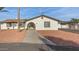 Classic home exterior featuring an arched entryway, neutral paint, and well-kept yard at 22312 W Hammond Dr, Buckeye, AZ 85326