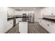 Well-lit kitchen with stainless steel appliances, island, and granite countertops at 22312 W Hammond Dr, Buckeye, AZ 85326