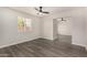 Living room boasts an open floor plan, neutral walls, and wood-look floors, creating a welcoming space at 22312 W Hammond Dr, Buckeye, AZ 85326