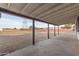Covered patio overlooking the spacious backyard featuring a putting green at 22312 W Hammond Dr, Buckeye, AZ 85326