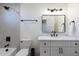 Modern bathroom featuring black fixtures, a walk-in shower and a white vanity with marble countertop at 3029 E Elm St, Phoenix, AZ 85016