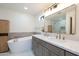 Luxurious bathroom with a freestanding tub, double vanity with marble countertop, and stylish fixtures at 3029 E Elm St, Phoenix, AZ 85016