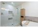 A modern bathroom features a walk-in shower with glass door, a freestanding tub, and neutral tile at 3029 E Elm St, Phoenix, AZ 85016