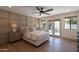 Stylish bedroom with a decorative wall, wood-look floors, ceiling fan, and access to the pool area at 3029 E Elm St, Phoenix, AZ 85016