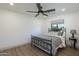 This bedroom features a ceiling fan, a large window, and a comfortable-looking bed with stylish bedding at 3029 E Elm St, Phoenix, AZ 85016