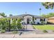 Charming single-story home with a manicured lawn, inviting walkway, and black trimmed windows at 3029 E Elm St, Phoenix, AZ 85016