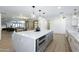 Spacious kitchen with island, modern pendant lights, and open layout flowing into the living area at 3029 E Elm St, Phoenix, AZ 85016