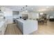Open kitchen with a large island, modern appliances, and wood floors flowing into the dining area at 3029 E Elm St, Phoenix, AZ 85016