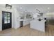 Bright kitchen with white cabinets, stainless steel appliances, and a stylish island with wood floors at 3029 E Elm St, Phoenix, AZ 85016