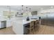 Modern kitchen with a large island, stainless steel appliances, and ample storage in white cabinets at 3029 E Elm St, Phoenix, AZ 85016