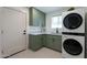 Stylish laundry room boasts modern LG washer/dryer, green cabinetry, white counters and a unique patterned tile floor at 3029 E Elm St, Phoenix, AZ 85016