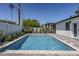Sparkling swimming pool with a safety fence, surrounded by lush greenery at 3029 E Elm St, Phoenix, AZ 85016